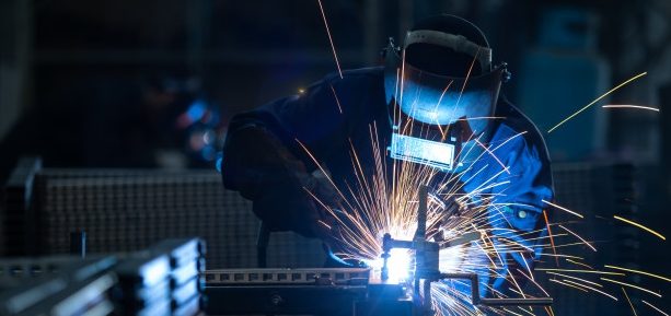 Welder at work with sparks